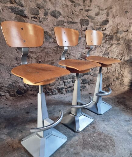 industrial swivel bar stools angled view showing metal base and wooden seat workshop chairs