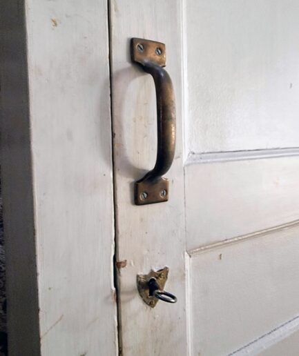 Close up of antique cabinet handle and key lock